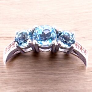 0.67 Carat Round Swiss Blue Topaz with White Topaz Accent 3 Stone Sterling Silver Ring Blue Topaz Platinum Jewelers MS